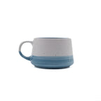 Speckled ceramic mug with blue accent on a white background
