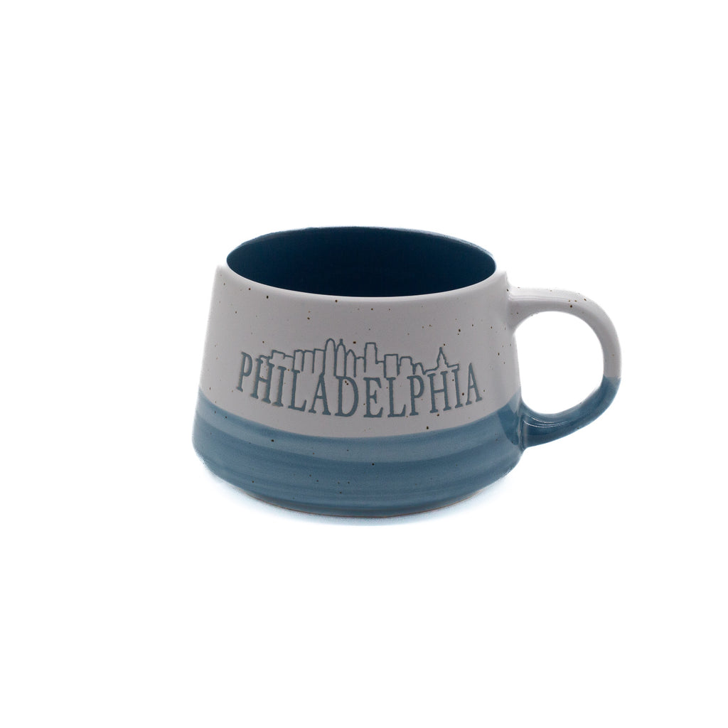 Speckled two-tone mug with blue interior, featuring the word 'Philadelphia' with an outline of the city skyline.