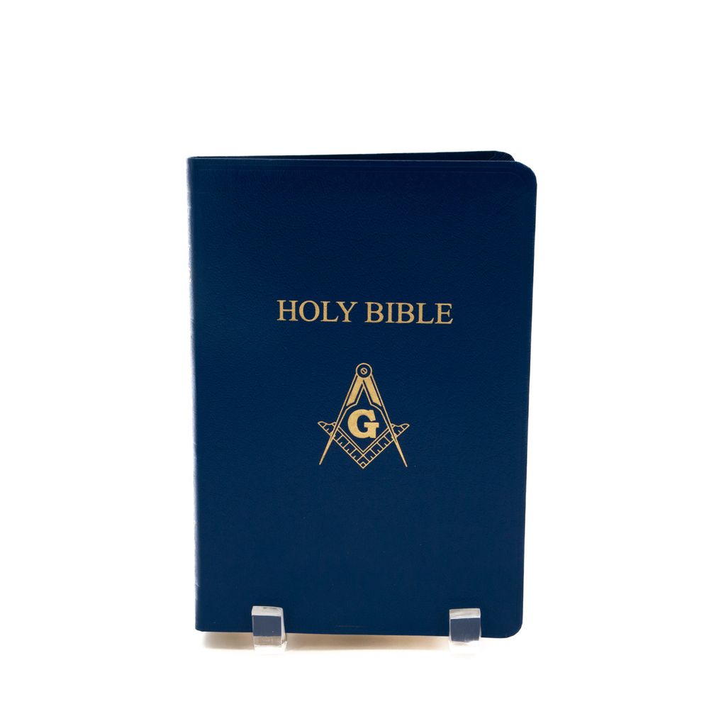 Blue Bible with gold Square and Compass on a white background