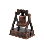 Bronze Liberty Bell-shaped pencil sharpener on a white background