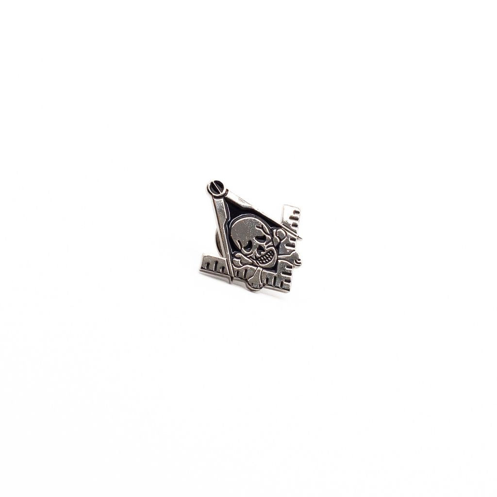 Silver lapel pin with skull and crossbones design on Square and Compasses.