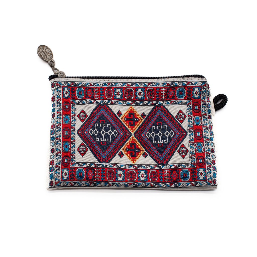Fabric pouch with a tan, red and blue pattern on a white background.
