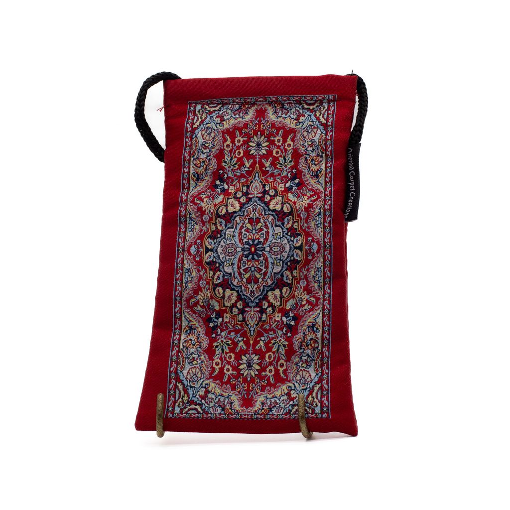 Red patterned pouch with a strap on a white background