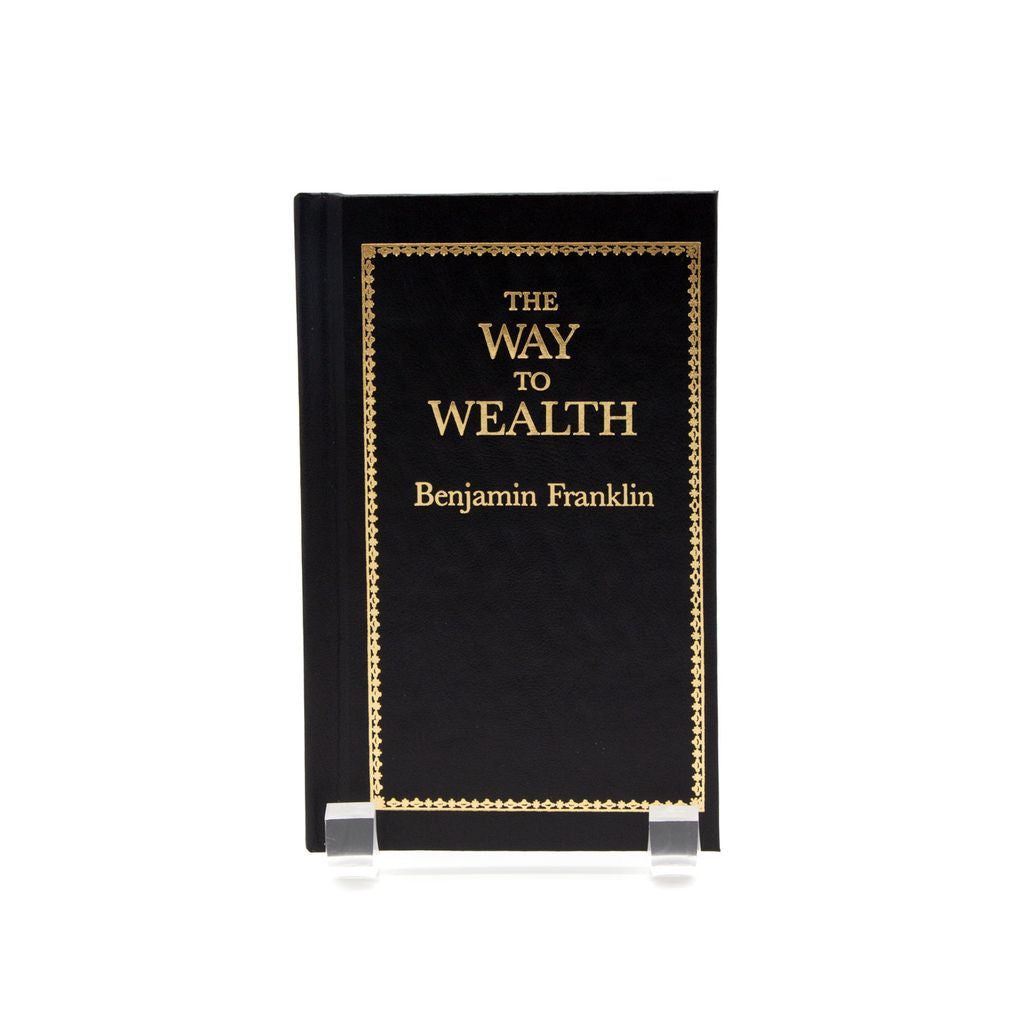 Book titled 'The Way to Wealth' by Benjamin Franklin on a stand with a white background