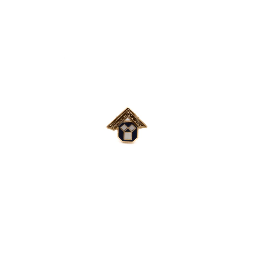 Lapel pin with gold, black and white geometric detail and gold triangular top resembling a square tool. 