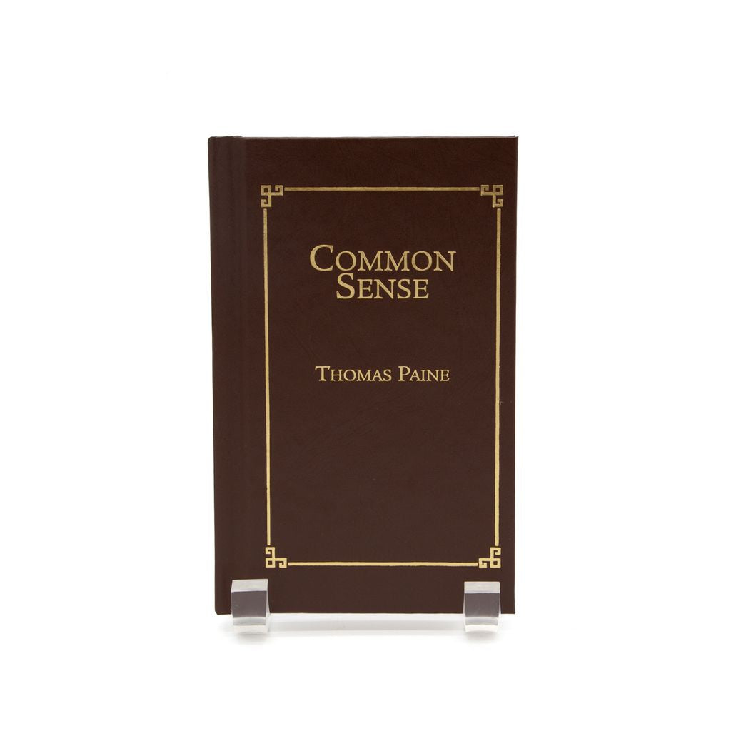 Brown book titled 'Common Sense' by Thomas Paine on a white background