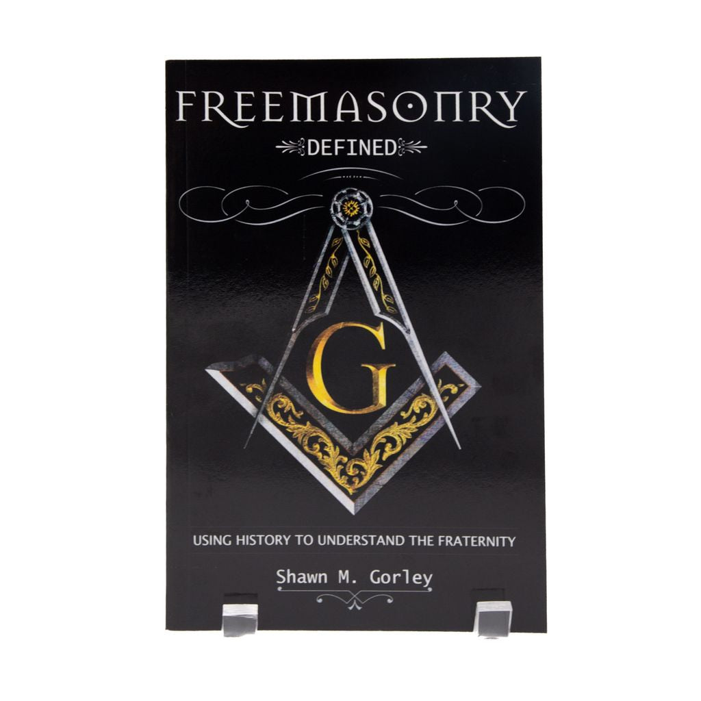 Book titled 'Freemasonry Defined' with Square and Compass on a black background