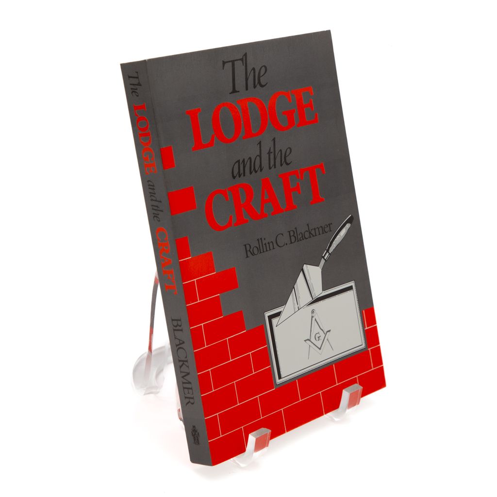 Book titled 'The Lodge and the Craft' by Rollin C. Blackmer on a stand with a white background