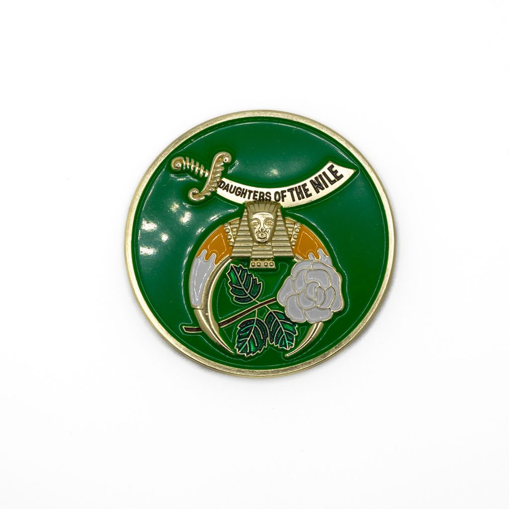 Circular green badge with sphinx, sword, and rose design with text, 'Daughters of the Nile' on a white background