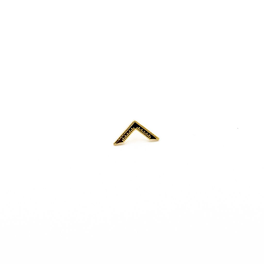 Gold triangle-shaped lapel pin on a white background