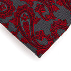 Red paisley pattern on a gray fabric background
