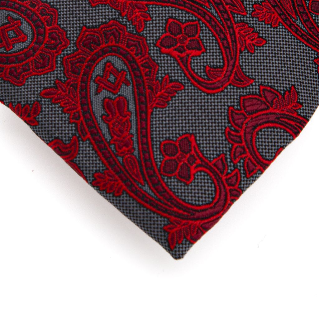 Red paisley pattern on a gray fabric background