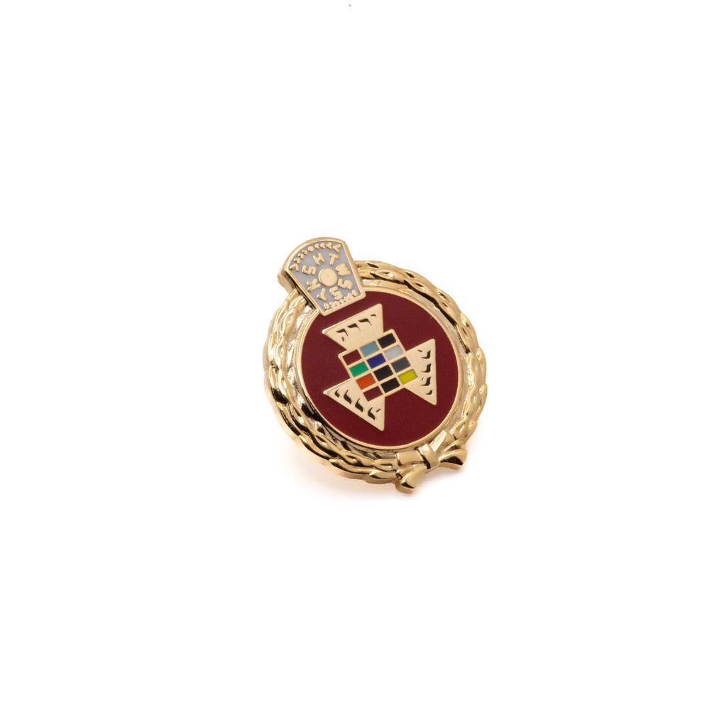 Decorative pin with a central geometric emblem on a white background
