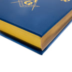 Closeup of corner of blue and gold book with gold page edges. 