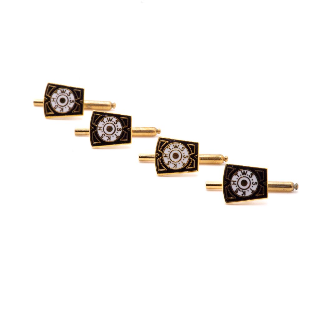 Set of four gold and black cufflinks with white circle design on a white background