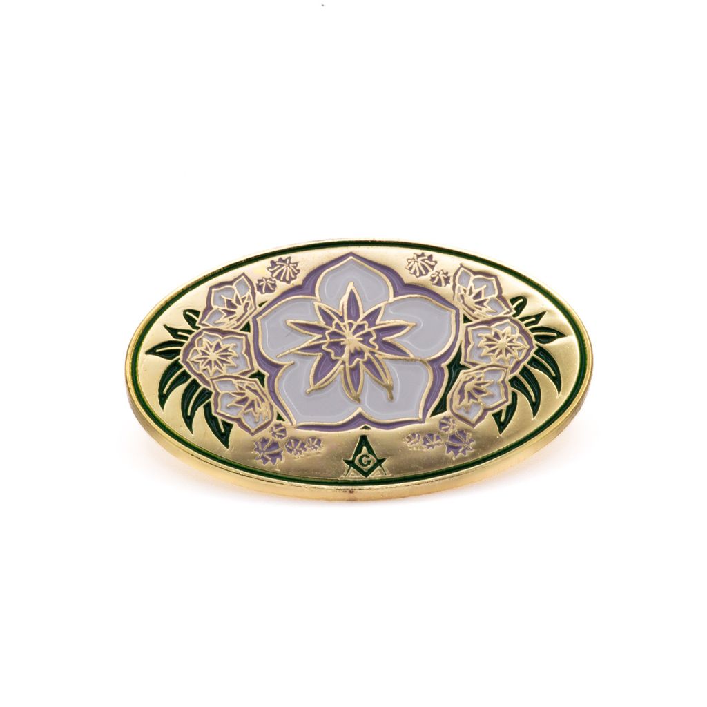 Decorative lapel pin with floral design on a white background