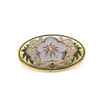 Decorative lapel pin with floral design on a white background