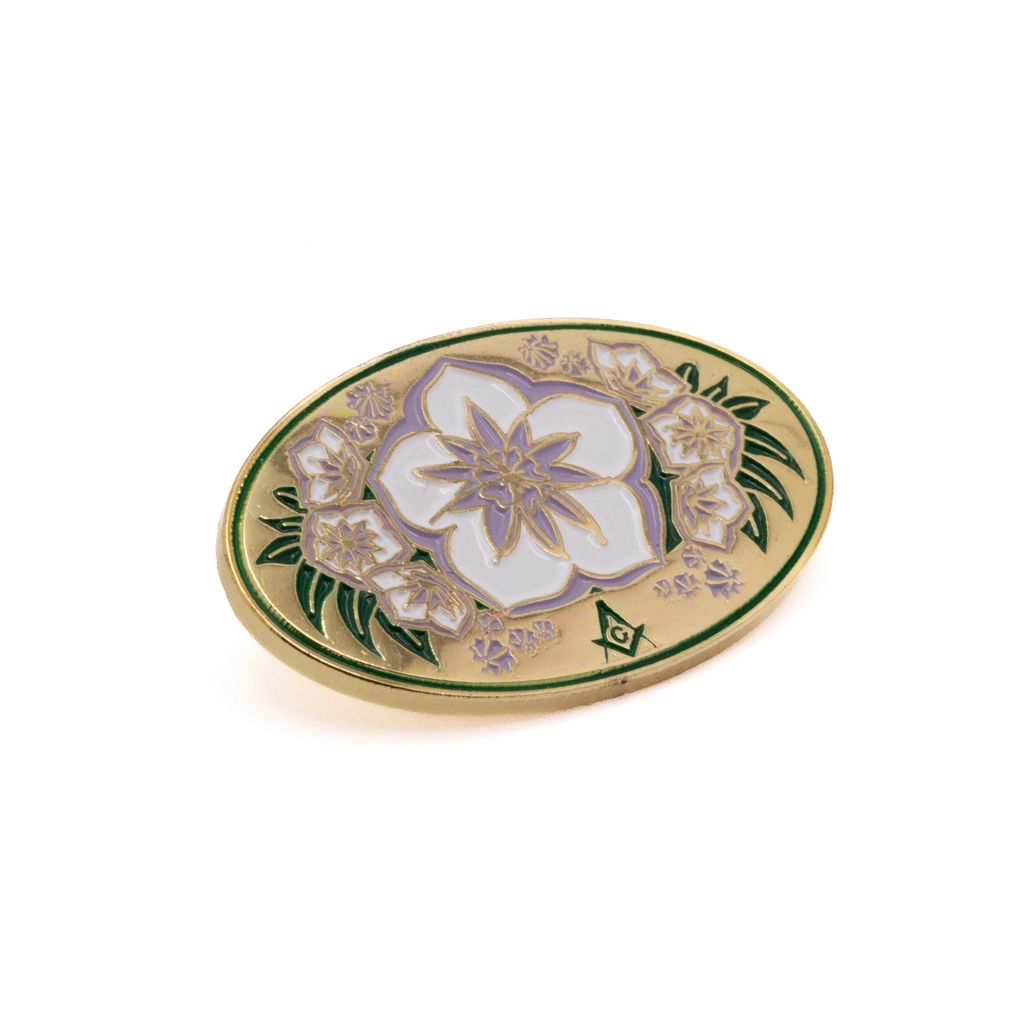 Decorative lapel pin with floral design on a white background