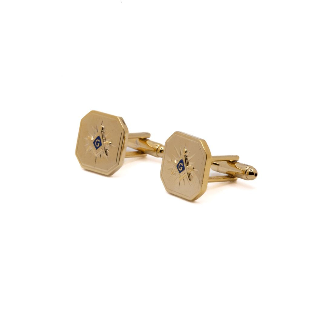 Gold cufflinks with Square and Compass design on a white background