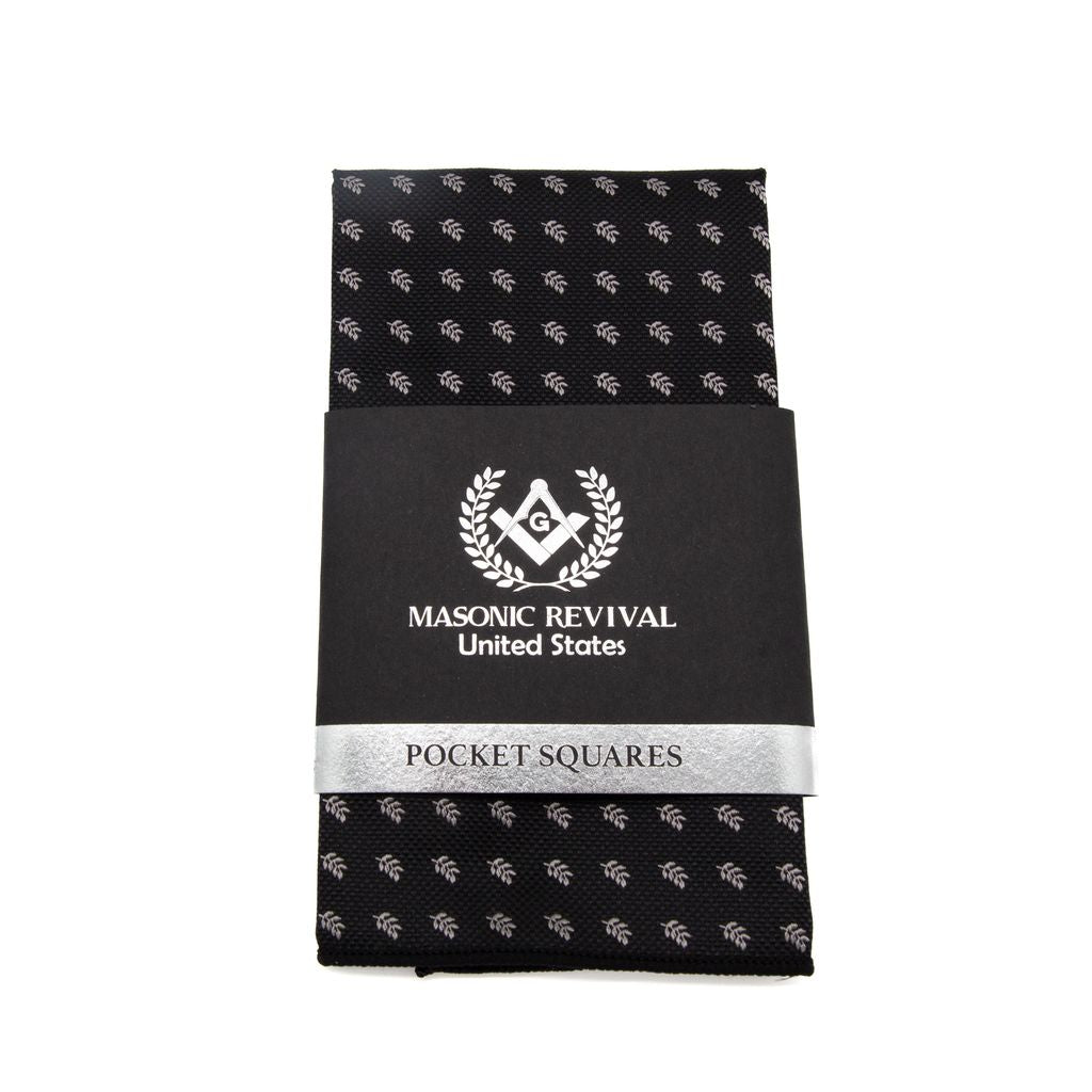 Black pocket square with white acacia patterns with black and silver packaging.