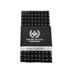 Black pocket square with white acacia patterns with black and silver packaging.