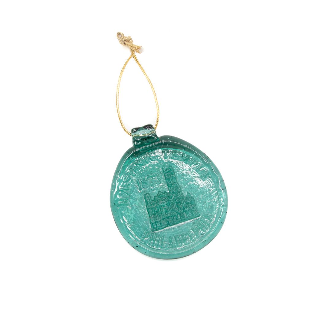 Green round suncatcher with a gold string on a white background