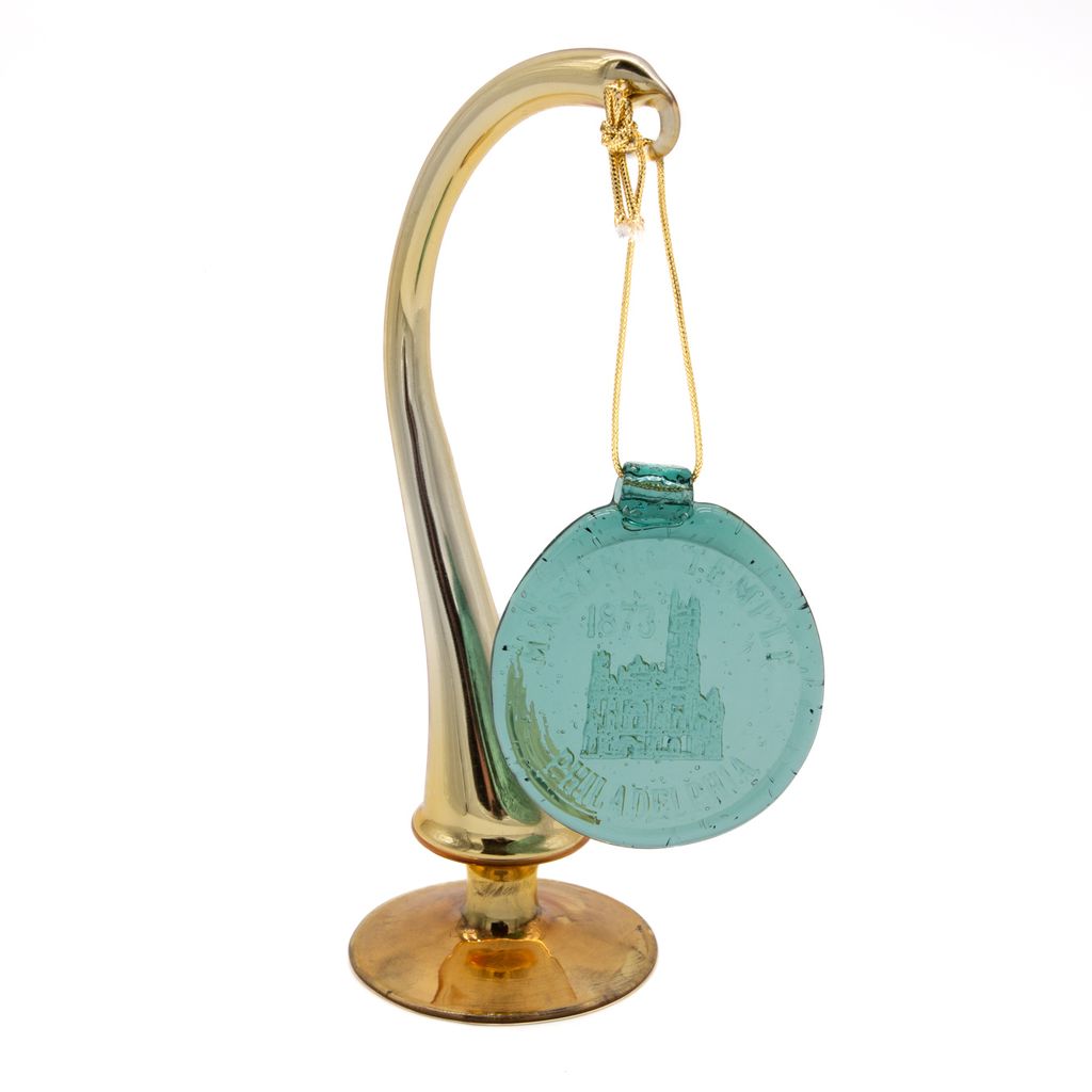 Green round suncatcher with a gold string hanging on gold stand on a white background