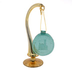 Green round suncatcher with a gold string hanging on gold stand on a white background