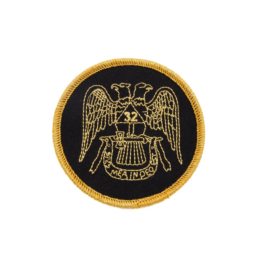 Circular patch with gold border and eagle design on a black background