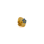 Gold and blue flower-shaped lapel pin on a white background