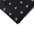 Black fabric with white skull and crossbones pattern