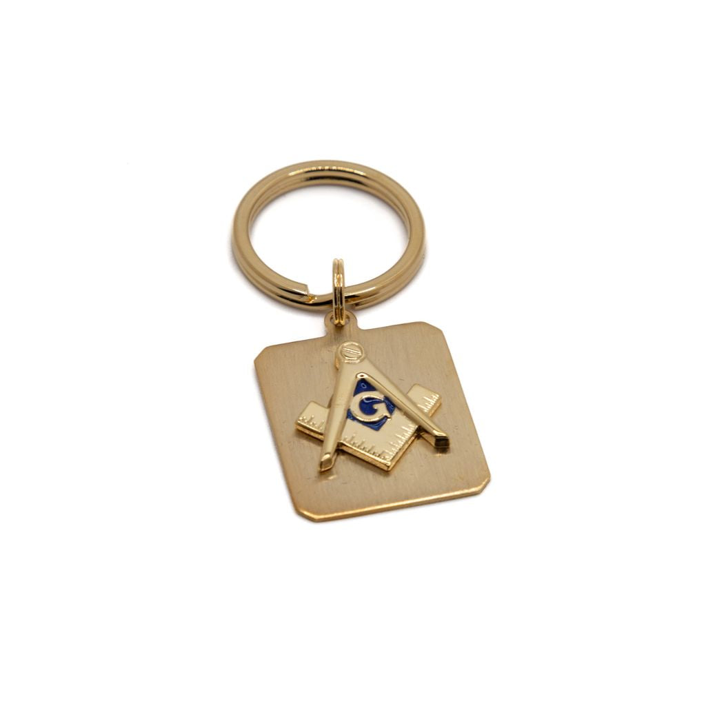 Gold keychain with square and compass on a white background