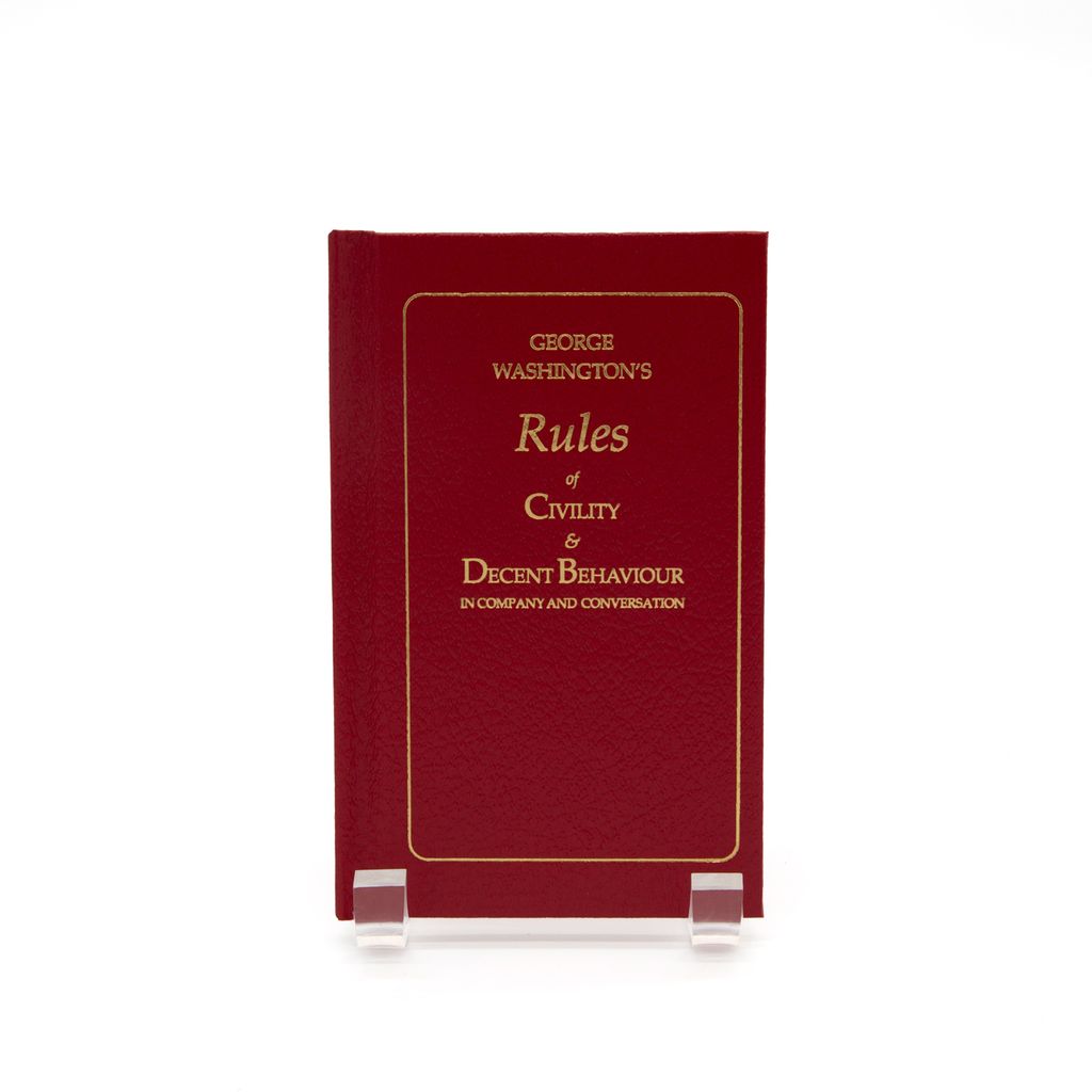 Red book titled 'George Washington's Rules of Civility & Decent Behaviour' on a white background
