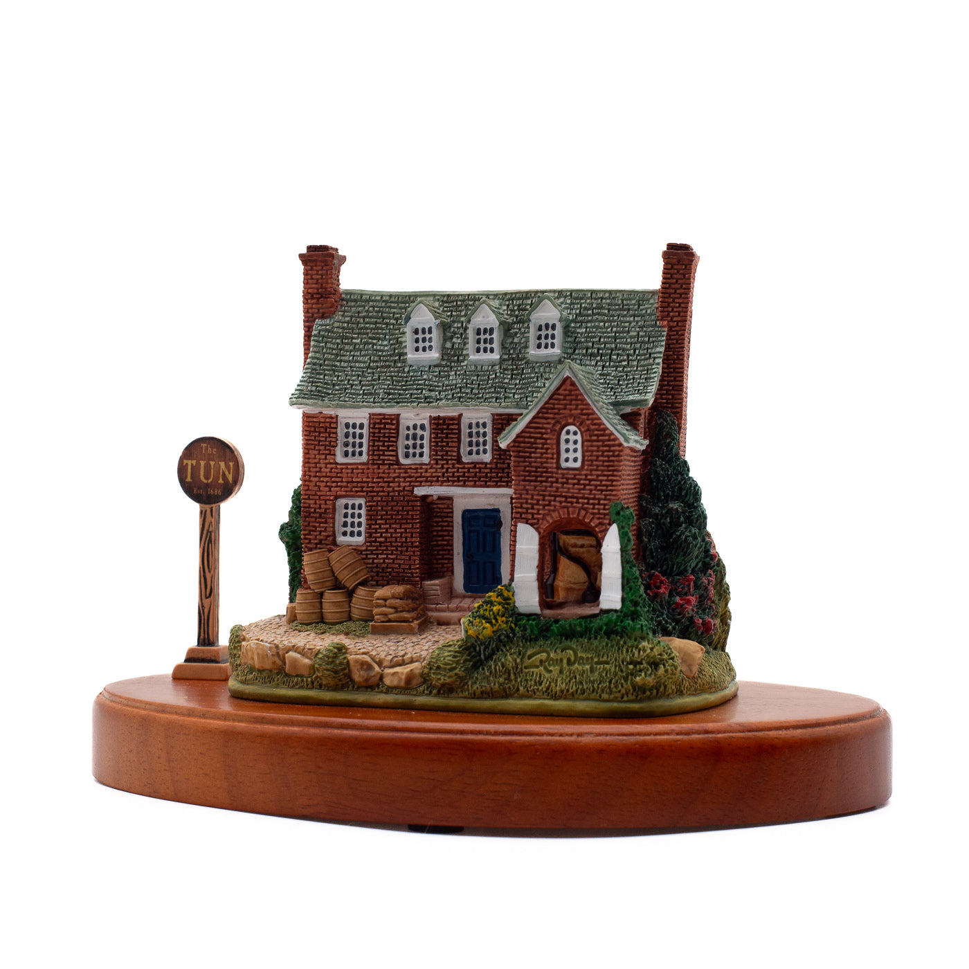 Back of a miniature of the Tun Tavern, a brick building with a blue back door.