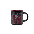 Black mug with 'Philadelphia' and city skyline design featuring the iconic red "LOVE" sculpture on a white background.