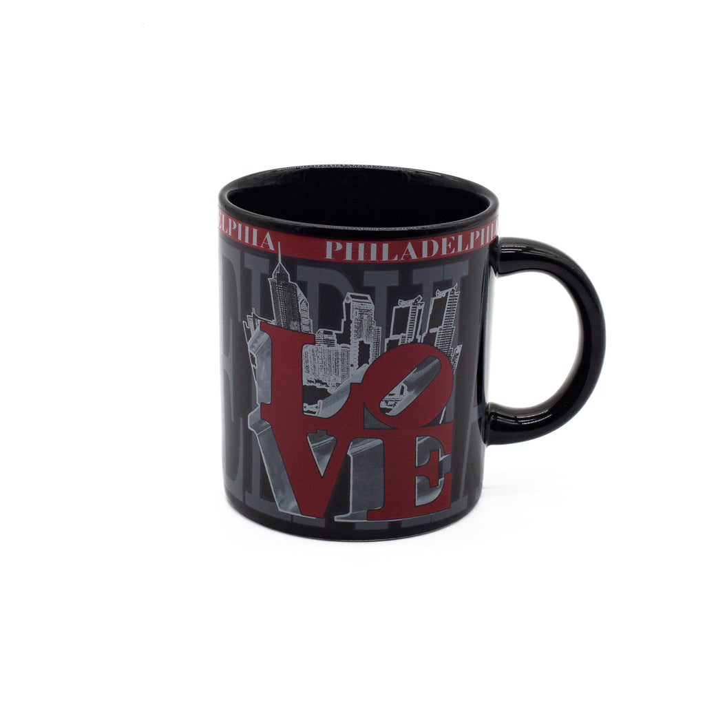 Black mug with 'Philadelphia' and city skyline design featuring the iconic red "LOVE" sculpture on a white background.